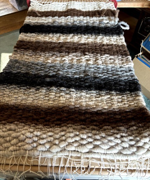 Handwoven alpaca fiber rug in natural colors
